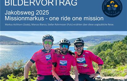 Three cyclists are wearing pink jerseys and smiling at the camera. In the background, a beautiful landscape with mountains and water can be seen.