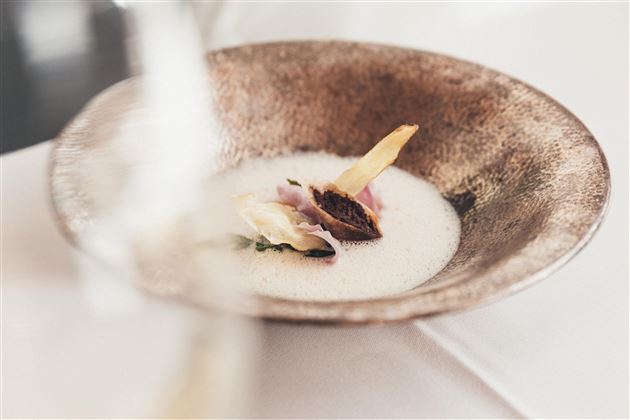 A artistically arranged dish in a decorative bowl. The ingredients are creatively combined, giving the food an elegant touch.