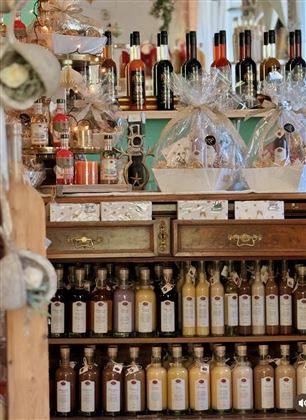 Ein schöner Ausstellungsstand mit verschiedenen Flaschen und Geschenkpäckchen. Die Regale sind gut gefüllt mit verschiedenen Getränken.