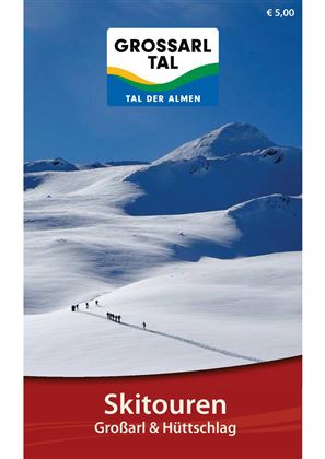 A wintry landscape with snow-covered mountains and a group of ski tourers. The sky is clear and blue, perfect for outdoor activities.