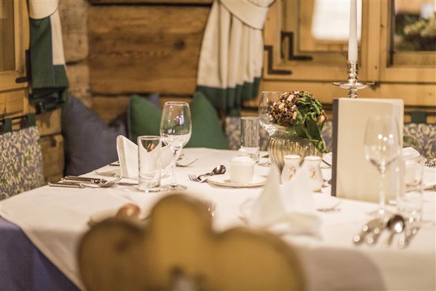 An elegantly set table in a cozy restaurant. The atmosphere is inviting with a view of atmospheric details.
