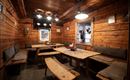 A cozy room with wooden walls and wooden furniture. The room is simply furnished and offers space to sit and relax.