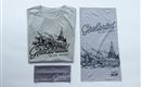 A gray T-shirt and a gray headband with the print "Grosartal - Valley of the Alps". There is also a large cloth with a mountain landscape and the same lettering.