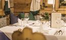 An elegantly set table in a cozy restaurant. The atmosphere is inviting with a view of atmospheric details.
