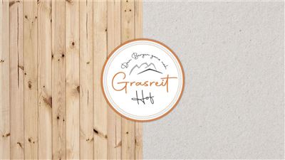 A logo of "Grasreit Hof" against a background of wood and paper elements. It conveys a rustic and inviting feeling.