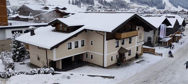 A cozy chalet-style house in the snow. Surrounded by a picturesque winter landscape.