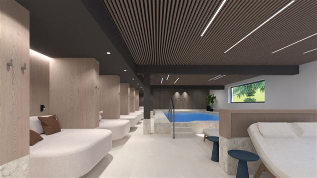 An elegant wellness area with a small pool and comfortable loungers. The wood paneling and soft colors create a relaxing atmosphere.