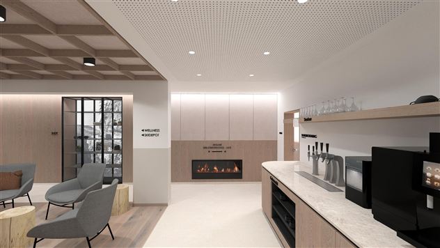 A modern room with comfortable armchairs and an elegant kitchenette. On the wall, there is an electric fireplace that creates a cozy atmosphere.