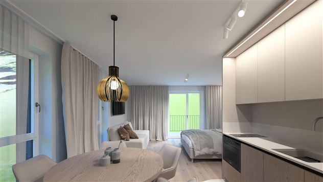 A modern room with a kitchenette, a dining area, and a bedroom.  
Large windows let in a lot of light.