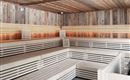 A modern sauna interior with wooden paneling and illuminated benches. The space offers a relaxing atmosphere for wellness and recovery.