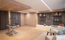 A modern room with wood-paneled walls and a light wood floor. In the corner stands equipment for fitness or therapy as well as decorative elements on a wall.