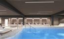 A modern wellness area with a clear, blue pool.  
Relaxation loungers invite you to linger.