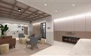 A modern lounge atmosphere with comfortable seating and a minimalist design. A decorative plant and some artworks complement the space.