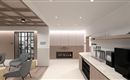 A modern room with comfortable armchairs and an elegant kitchenette. On the wall, there is an electric fireplace that creates a cozy atmosphere.